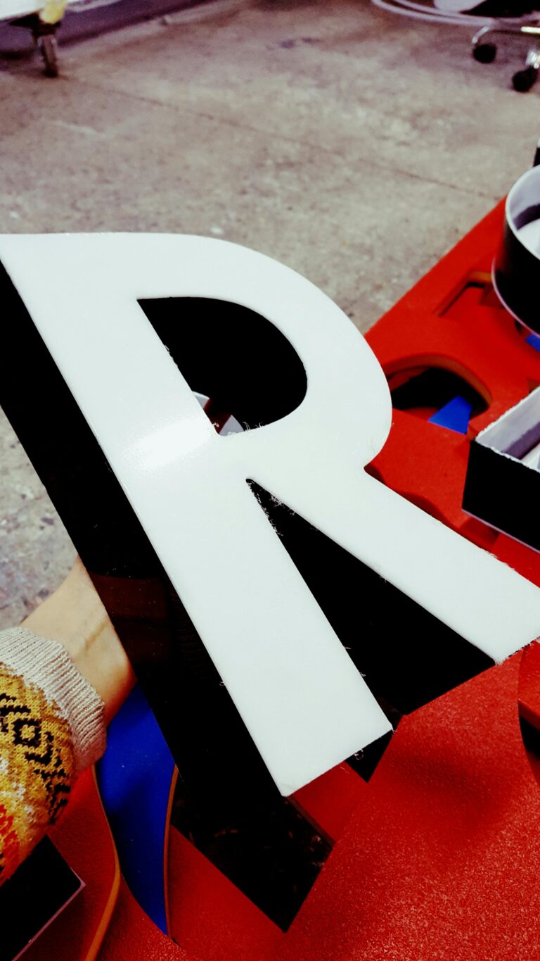 Artistic workshop scene with handmade letter R in vibrant colors.